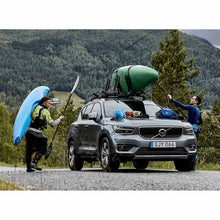 Load image into Gallery viewer, Paddlers loading kayaks onto the Thule Hull-a-Port XTR